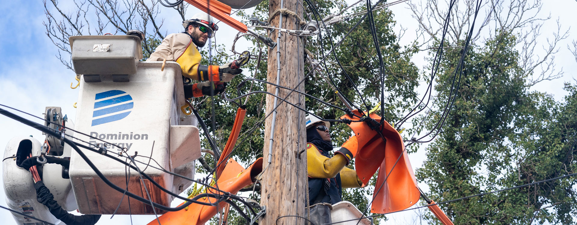 Dominion Energy lineworkers repair power lines damaged during a storm. 