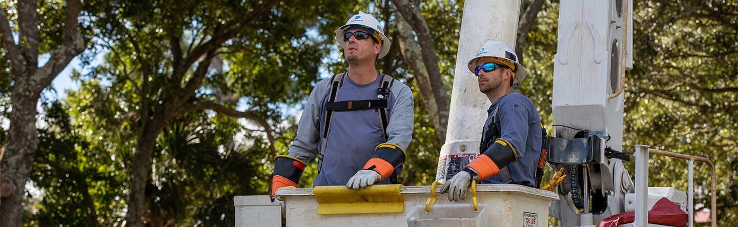 Dominion Energy Employees Surveying Job in Bucket Truck