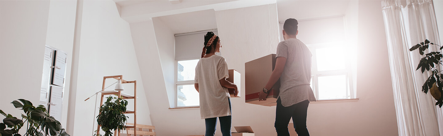 Couple Moving Boxes Out of Home