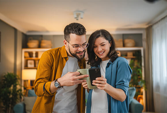Couple Looking At Mobile Phone
