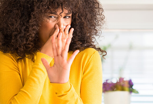 Lady Holding Nose Because of Bad Smell