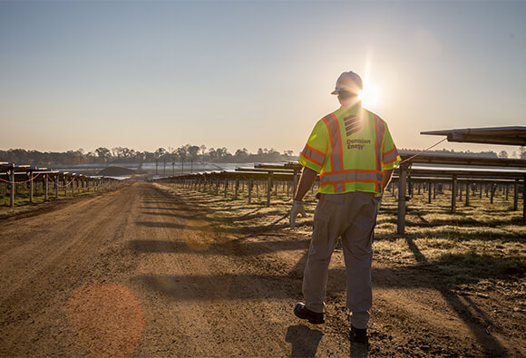 Dominion Energy Employee Walking in Solar Field