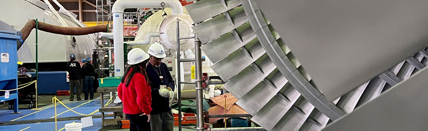 Inside facility with people in hardhats