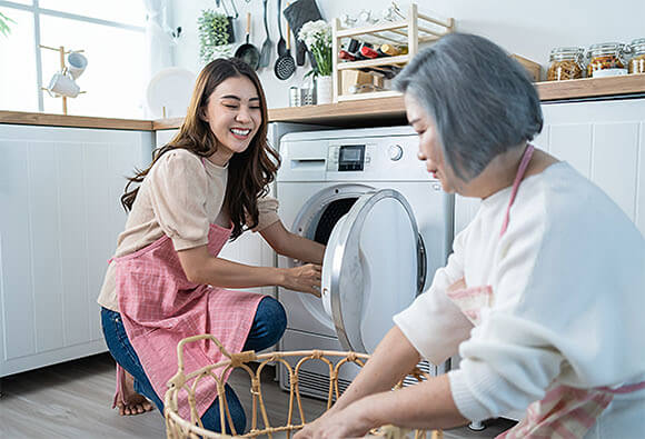 Mother and Daughter Doing Laundry Together