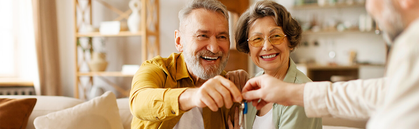 Property Manager Handing Couple Keys to House