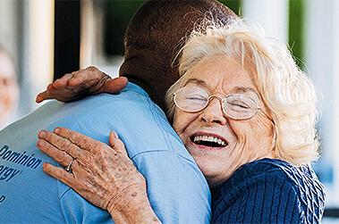 Lady Hugging Dominion Energy Volunteer