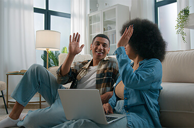 Couple High Fiving After Paying Bill Online