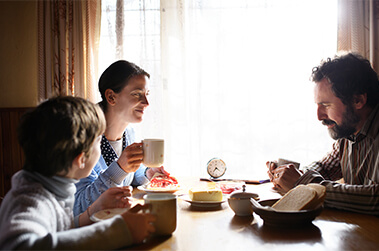 Family Sitting Around Kitchen Table