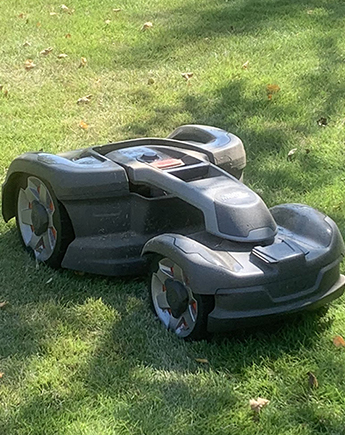 Robotic mower on green grass