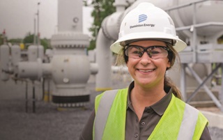 Smiling employee with helmet and goggles